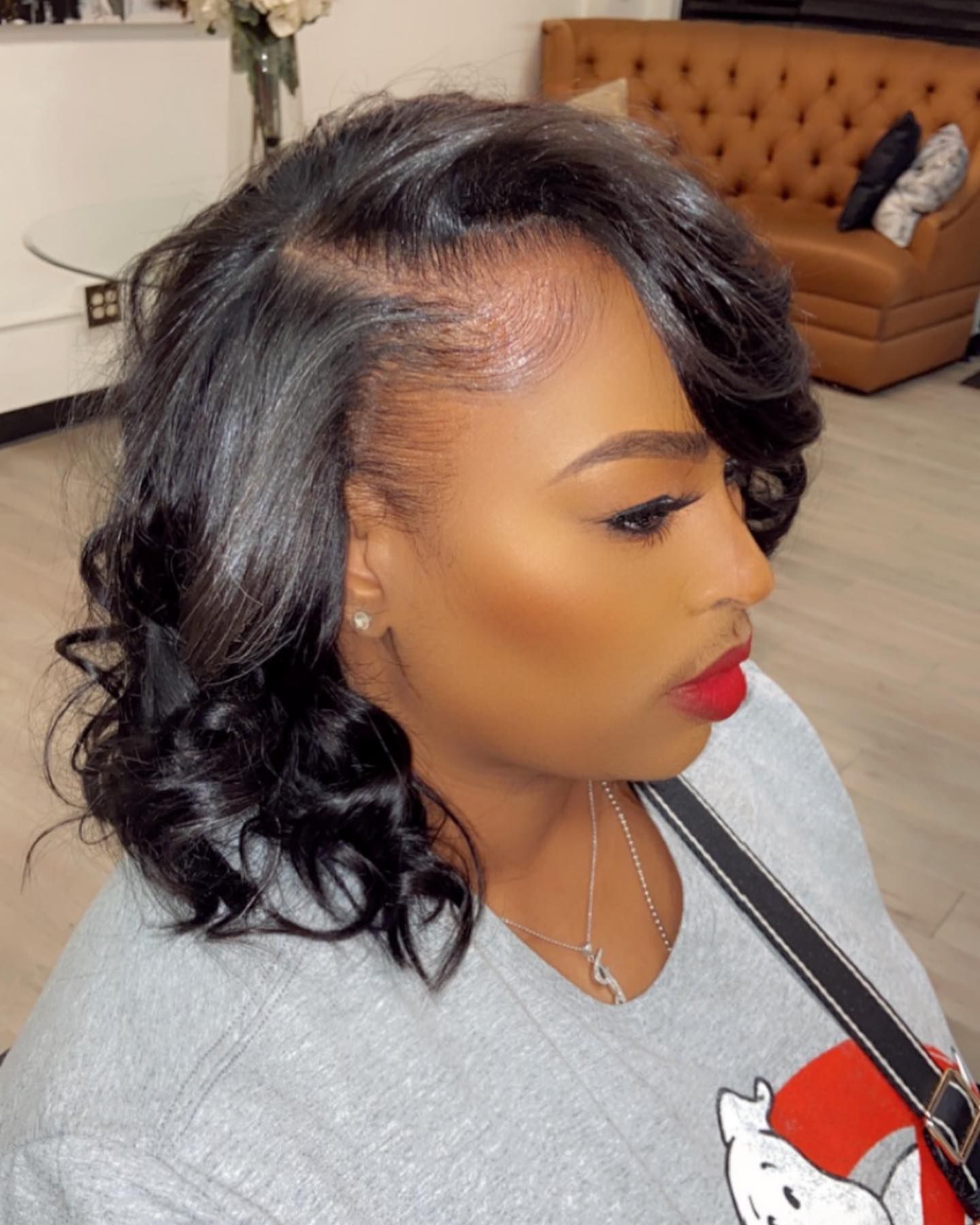 Glossy silk press side part soft curls Frisco hairstylist